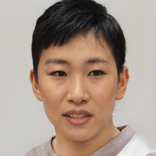 Joyful asian young-adult female with short  black hair and brown eyes
