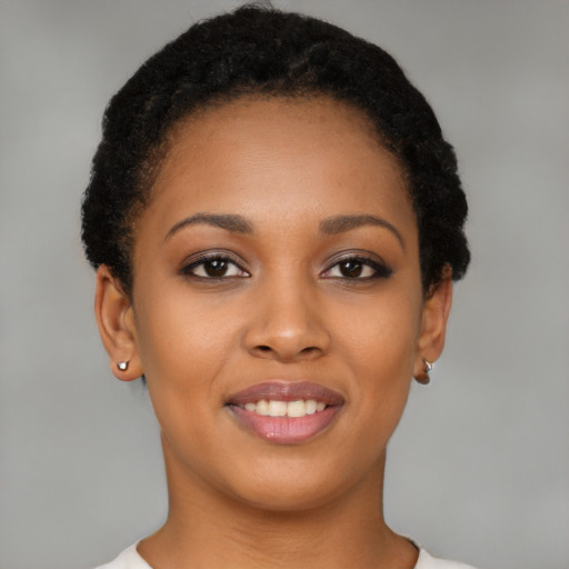 Joyful black young-adult female with short  brown hair and brown eyes
