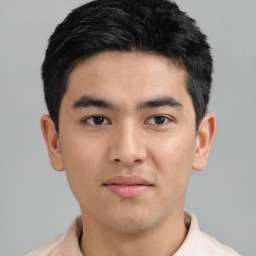 Joyful asian young-adult male with short  black hair and brown eyes