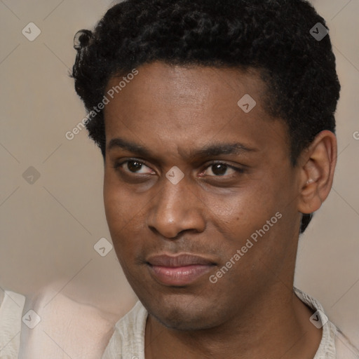 Joyful black young-adult male with short  brown hair and brown eyes