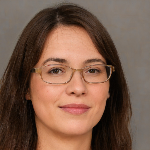 Joyful white adult female with long  brown hair and grey eyes