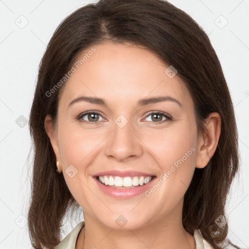 Joyful white young-adult female with medium  brown hair and grey eyes