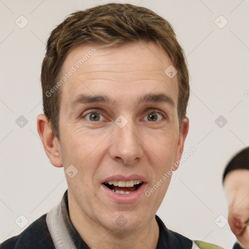 Joyful white adult male with short  brown hair and grey eyes