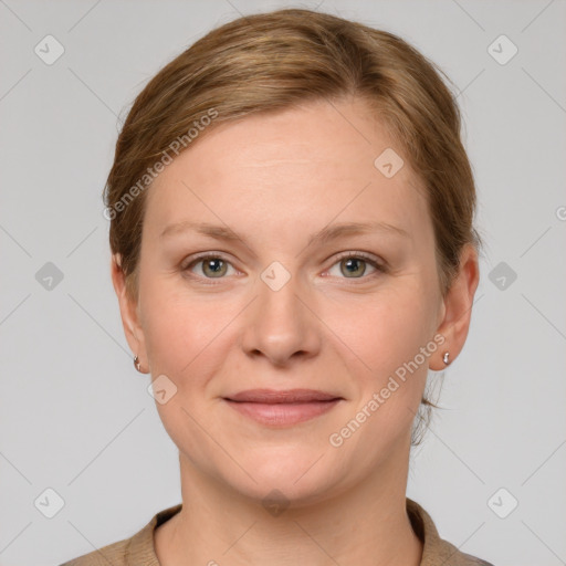 Joyful white young-adult female with short  brown hair and grey eyes