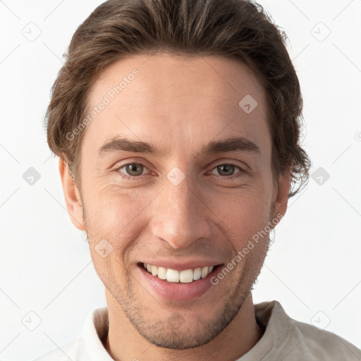 Joyful white young-adult male with short  brown hair and grey eyes