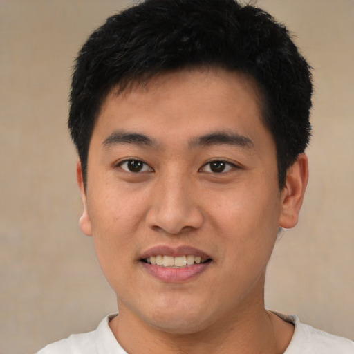 Joyful asian young-adult male with short  black hair and brown eyes