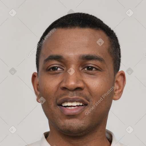 Joyful black young-adult male with short  black hair and brown eyes