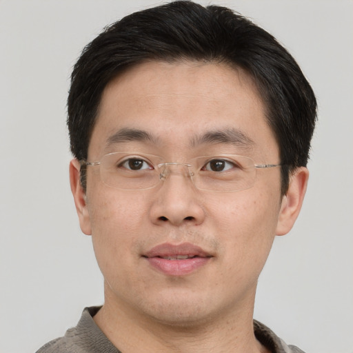 Joyful asian adult male with short  brown hair and brown eyes