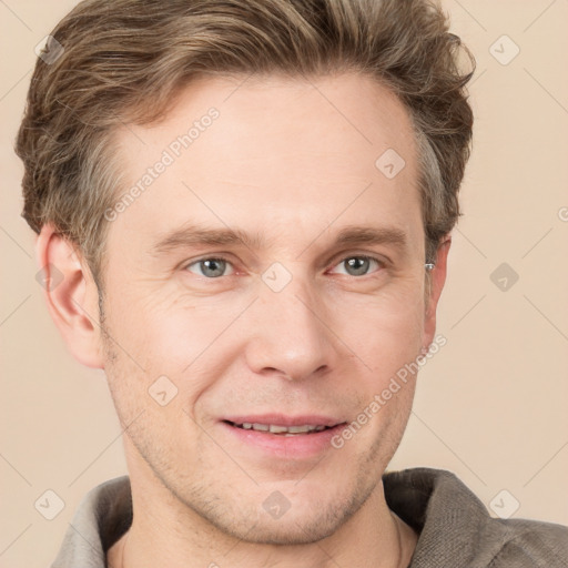 Joyful white adult male with short  brown hair and grey eyes