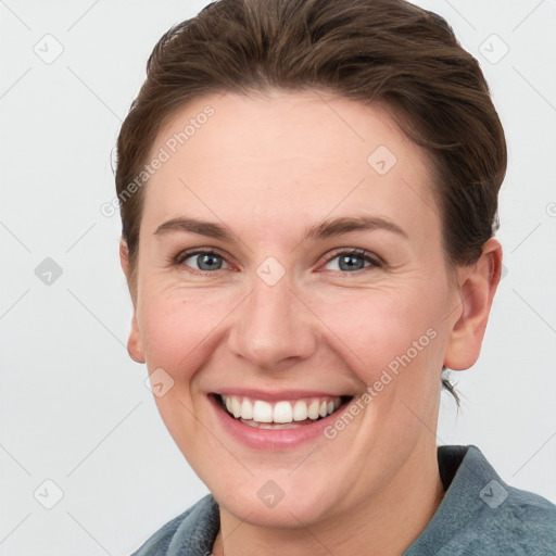 Joyful white young-adult female with short  brown hair and grey eyes