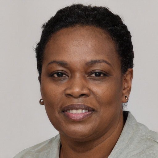 Joyful black adult female with short  black hair and brown eyes