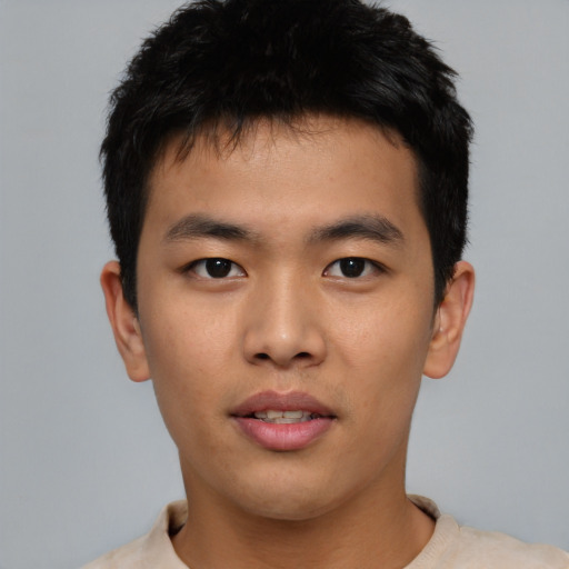 Joyful asian young-adult male with short  black hair and brown eyes