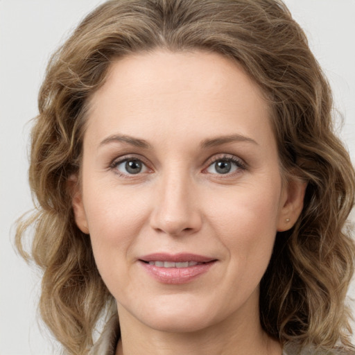 Joyful white young-adult female with medium  brown hair and green eyes