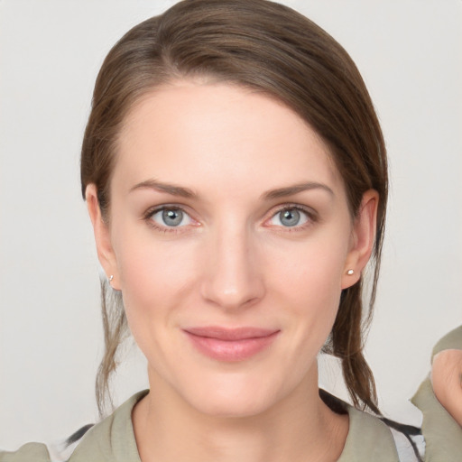 Joyful white young-adult female with medium  brown hair and grey eyes