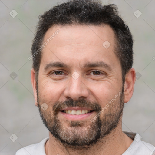 Joyful white adult male with short  black hair and brown eyes