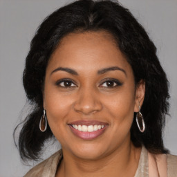 Joyful black young-adult female with medium  brown hair and brown eyes