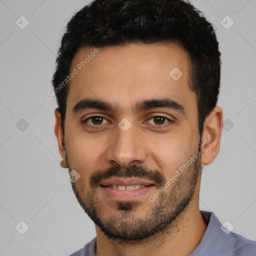 Joyful latino young-adult male with short  black hair and brown eyes