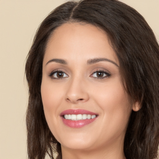 Joyful white young-adult female with long  brown hair and brown eyes