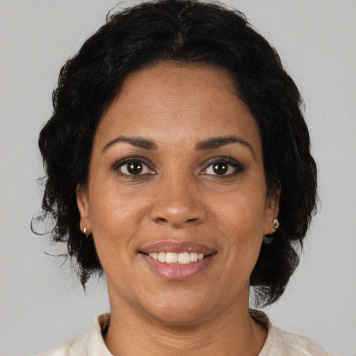 Joyful black adult female with medium  brown hair and brown eyes