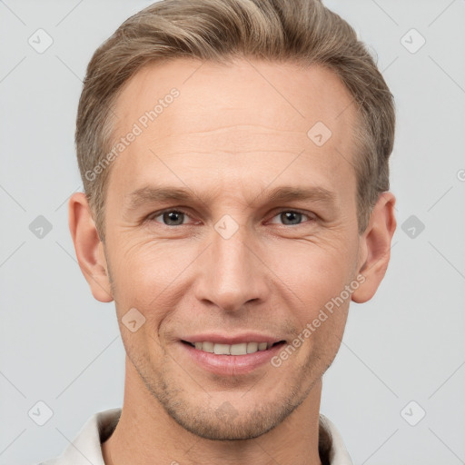 Joyful white adult male with short  brown hair and grey eyes