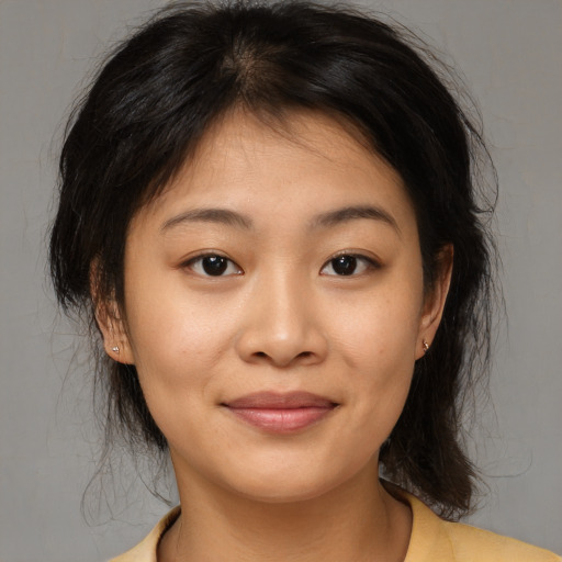 Joyful asian young-adult female with medium  brown hair and brown eyes