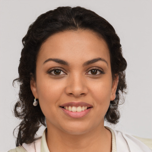 Joyful latino young-adult female with medium  brown hair and brown eyes