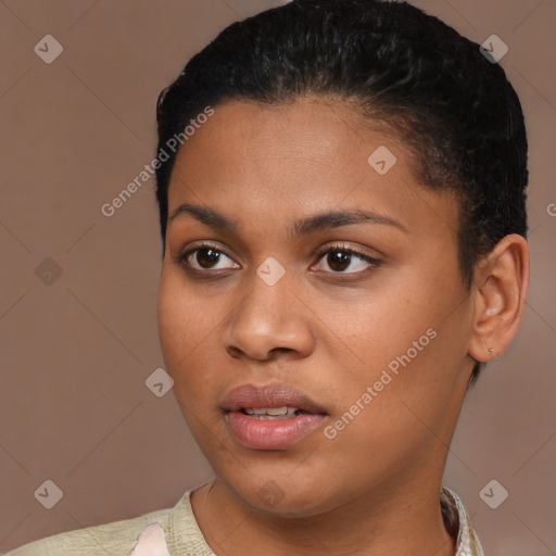 Joyful black young-adult female with short  black hair and brown eyes