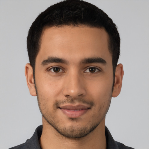 Joyful latino young-adult male with short  black hair and brown eyes