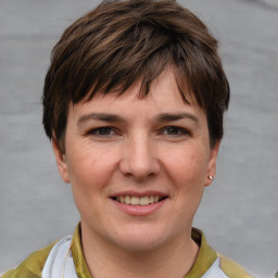 Joyful white young-adult female with short  brown hair and grey eyes