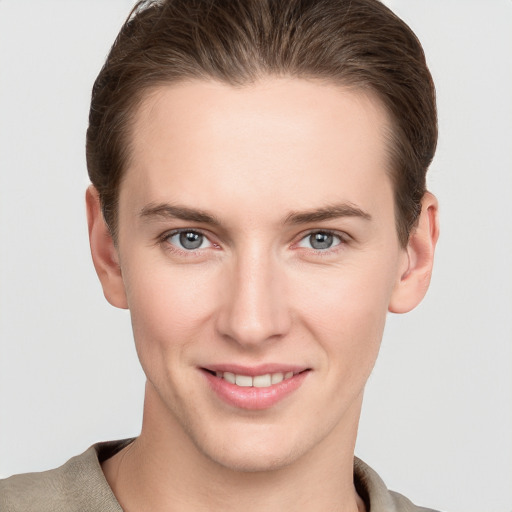 Joyful white young-adult female with short  brown hair and grey eyes