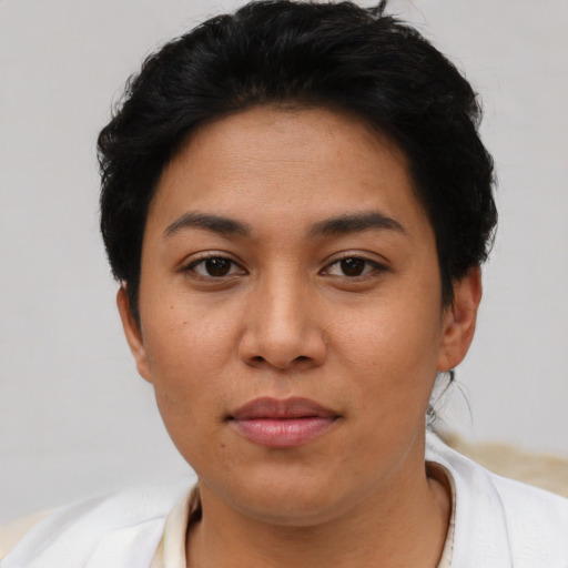 Joyful latino young-adult female with short  brown hair and brown eyes