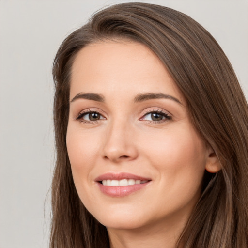 Joyful white young-adult female with long  brown hair and brown eyes