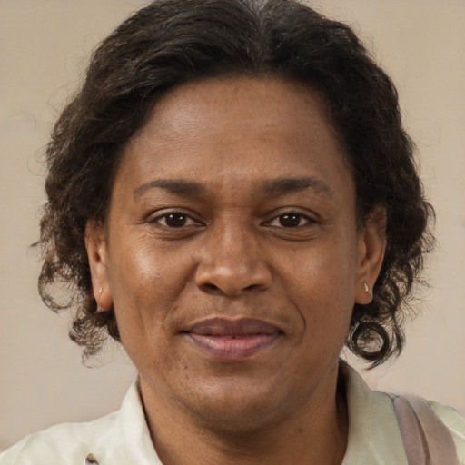 Joyful latino adult female with short  brown hair and brown eyes