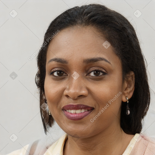 Joyful black adult female with medium  brown hair and brown eyes