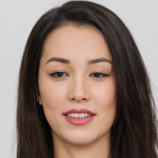 Joyful asian young-adult female with long  brown hair and brown eyes