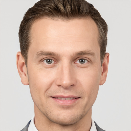 Joyful white adult male with short  brown hair and grey eyes