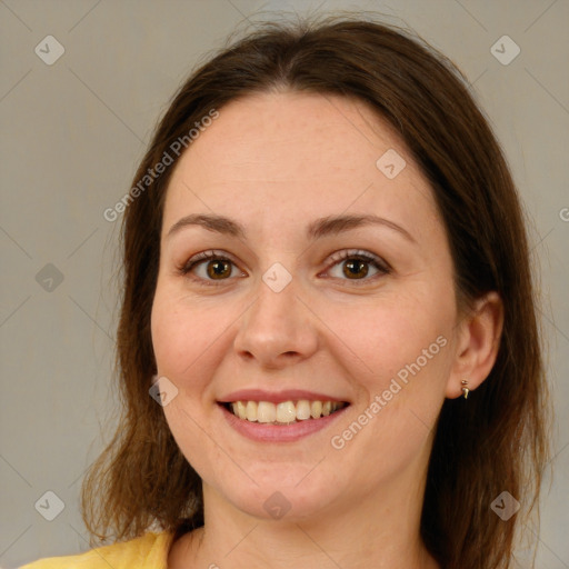 Joyful white adult female with medium  brown hair and green eyes