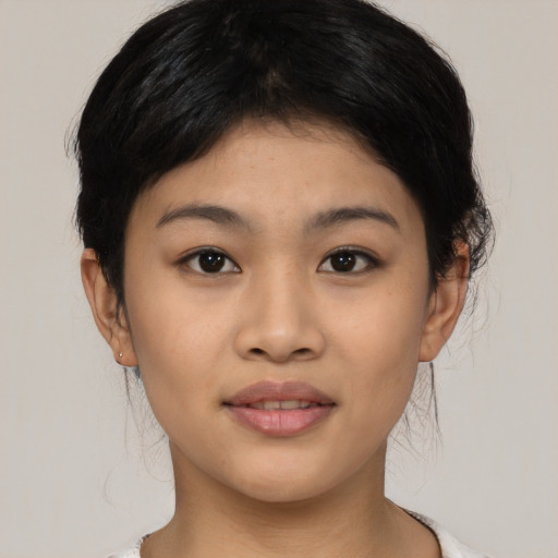 Joyful asian young-adult female with medium  black hair and brown eyes