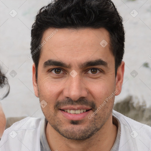 Joyful white young-adult male with short  black hair and brown eyes