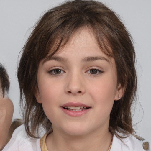 Joyful white child female with medium  brown hair and brown eyes