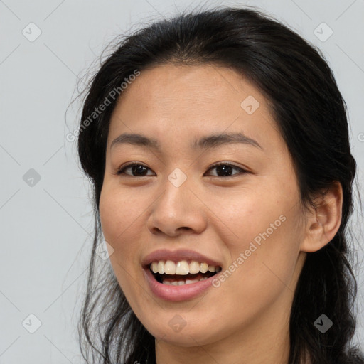 Joyful white young-adult female with long  brown hair and brown eyes