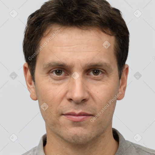 Joyful white adult male with short  brown hair and grey eyes