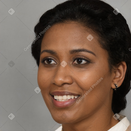 Joyful black young-adult female with short  black hair and brown eyes