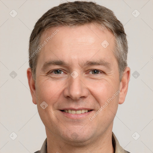 Joyful white adult male with short  brown hair and brown eyes