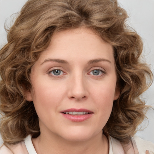 Joyful white young-adult female with medium  brown hair and green eyes