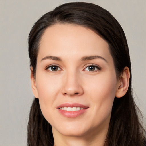 Joyful white young-adult female with long  brown hair and brown eyes