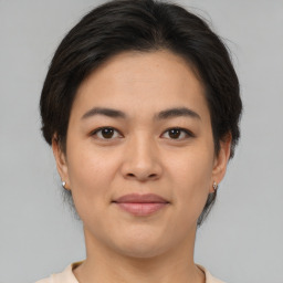 Joyful asian young-adult female with medium  brown hair and brown eyes