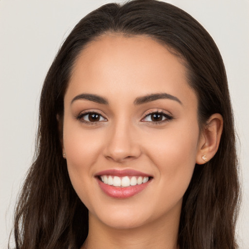 Joyful white young-adult female with long  brown hair and brown eyes