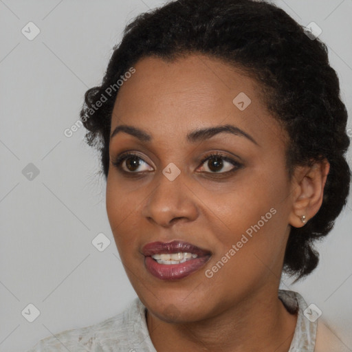 Joyful black young-adult female with short  brown hair and brown eyes