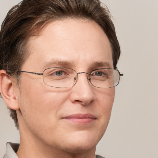 Joyful white adult male with short  brown hair and grey eyes